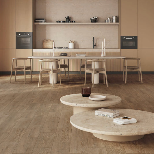 Modern kitchen with wooden flooring and a round marble coffee table.