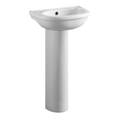 A white ceramic pedestal sink in a bathroom setting.