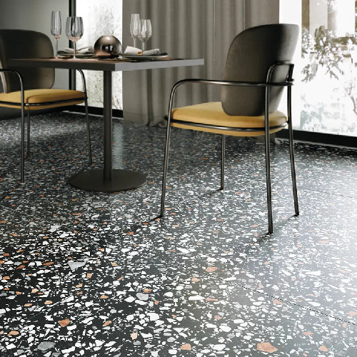 Dining area with chairs and a table on a terrazzo floor.