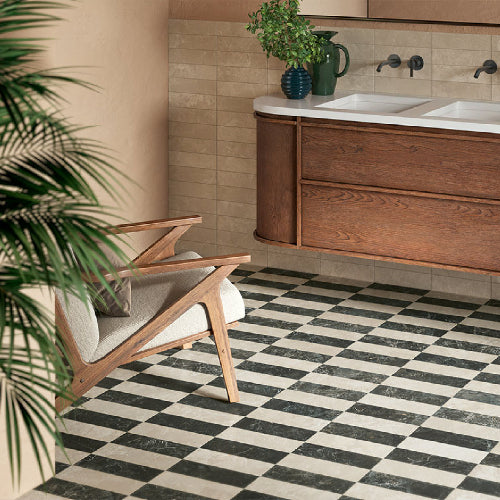 Bathroom with wooden vanity, checkered floor, and plant