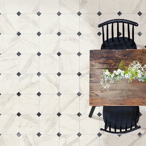 Wooden table with flowers on a tiled floor with geometric pattern