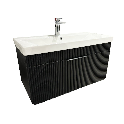 A black bathroom vanity unit with a white basin and gold tap.