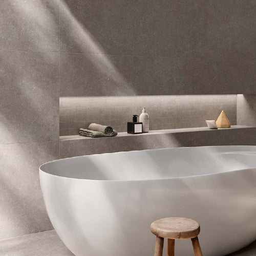 Modern bathroom with a freestanding bathtub, wooden stool, and minimal decor.
