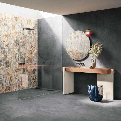 Modern bathroom with glass shower enclosure, round mirror, and wooden vanity.