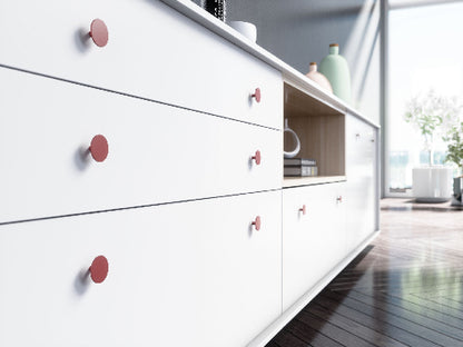 White dresser with brushed brass knobs in a modern room setting