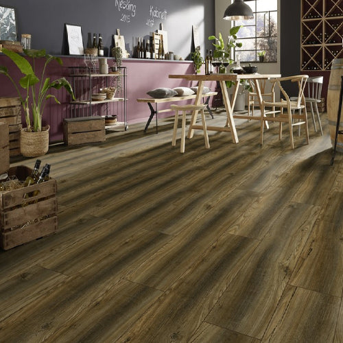 Wooden flooring in a room with a dining table and chairs.