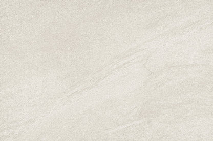 A close-up of a light warm gray or beige stone-like surface with subtle veining and a matte texture.