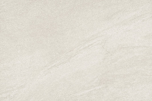 A close-up of a light warm gray or beige stone-like surface with subtle veining and a matte texture.