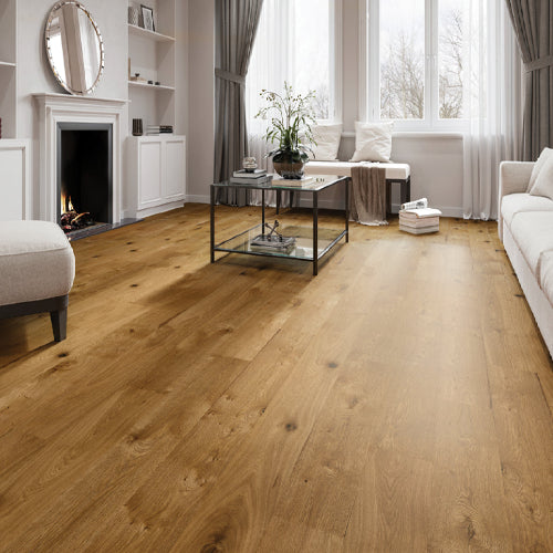 Living room with wooden flooring, white walls, and modern decor.