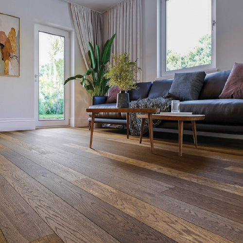 Living room with wooden flooring, sofa, and decorative elements.