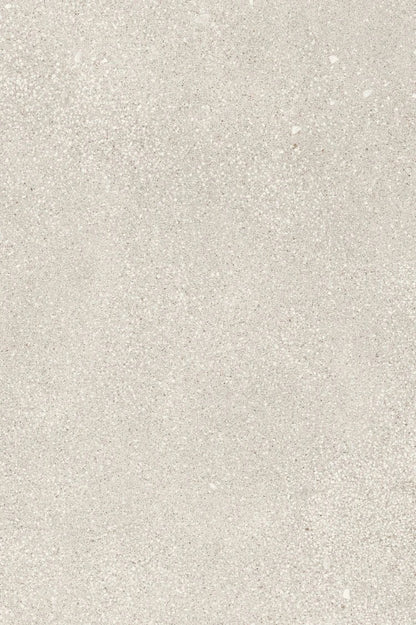 Close-up texture of small pearl-toned gravel aggregate, showing a fine mix of light gray, cream, and white speckled stone particles in a granular pattern.
