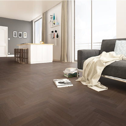 Modern living room with dark wooden floor, gray sofa, and white walls.