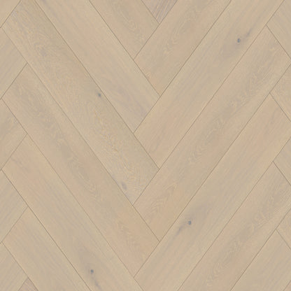 Wooden floor with herringbone pattern in beige and brown tones
