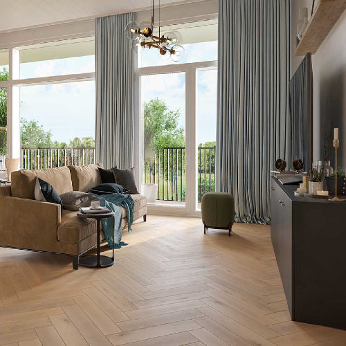 Modern living room with a large window, beige sofa, and decorative items.