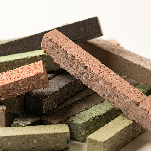 Stack of multicolored bricks on a white background
