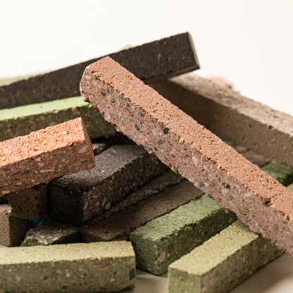 Stack of multicolored bricks on a white background