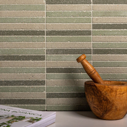 Wooden mortar and pestle against a patterned tile wall