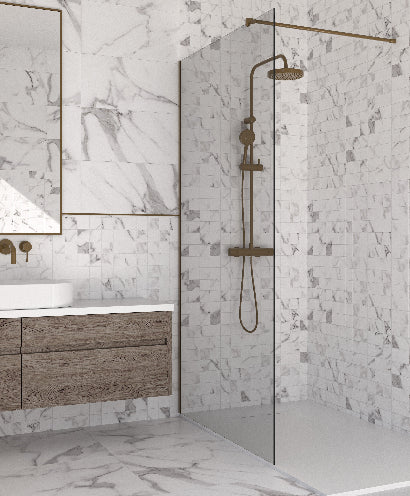 Modern bathroom with marble walls, wooden vanity, and glass shower enclosure.