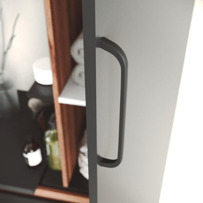 Close-up of a black cabinet handle on a white cabinet with shelves in the background.