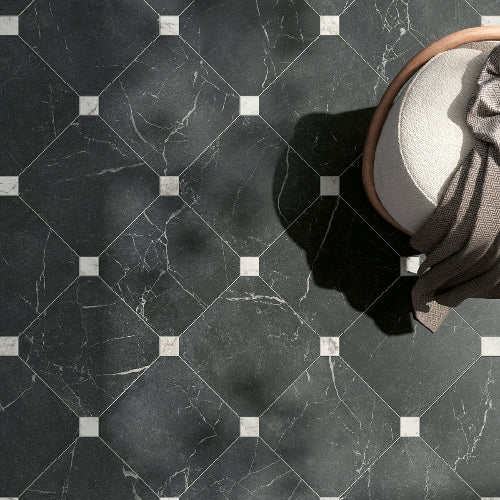 Hexagonal black marble tiles with white accents on a floor.