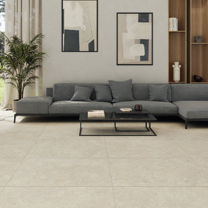 Modern living room with a gray sectional sofa, coffee table, and abstract art on the wall.