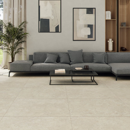 Modern living room with a gray sectional sofa, coffee table, and abstract art on the wall.