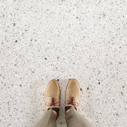 Tan shoes on a speckled floor