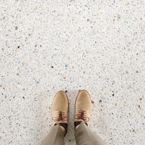 Tan shoes on a speckled floor