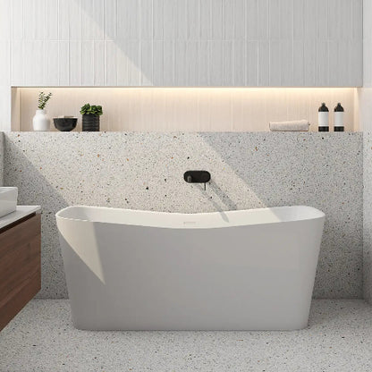 Modern bathroom with a freestanding bathtub against a textured wall.
