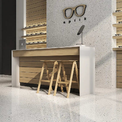 Modern interior design with wooden stools and a reception desk against a concrete wall with 'Optik' branding.