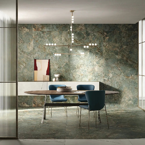 Modern dining room with marble wall, round table, and blue chairs.